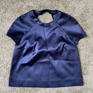 Satin open back blouse.